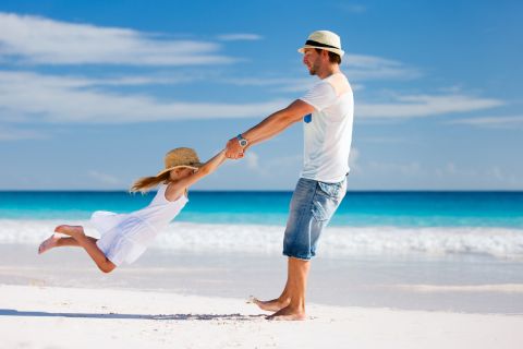 a man on vacation playing with a child